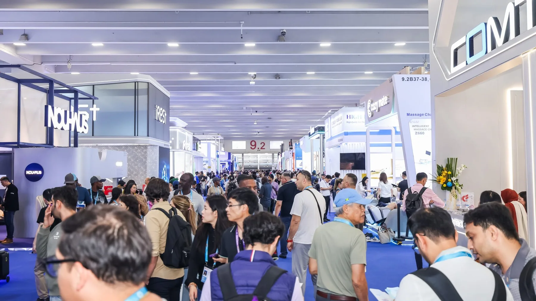 Busy Canton Fair aisle with international buyers visiting product booths