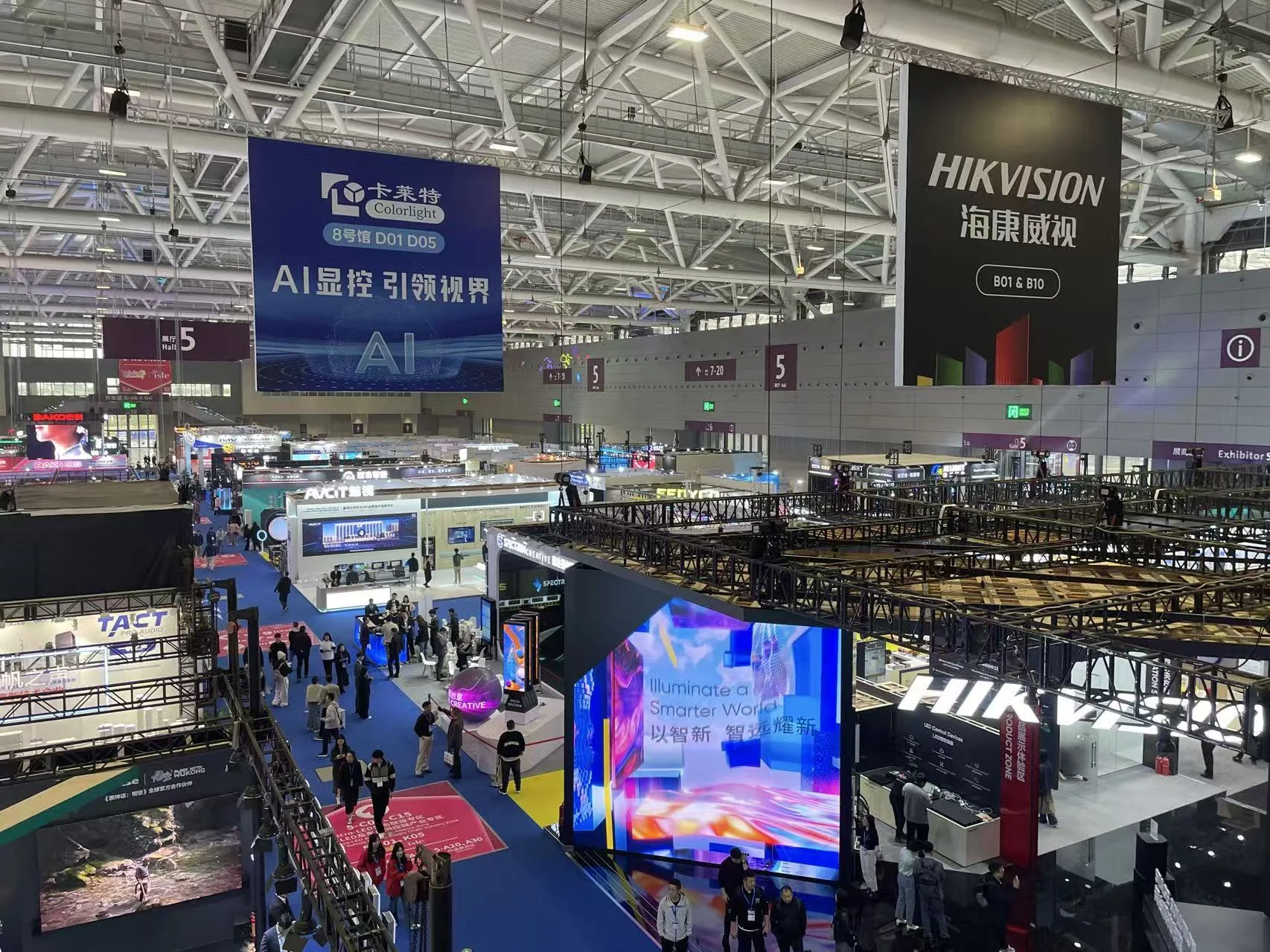 Wide view of the ISLE 2025 exhibition hall in Shenzhen with LED display booths and visible Colorlight and Hikvision signage