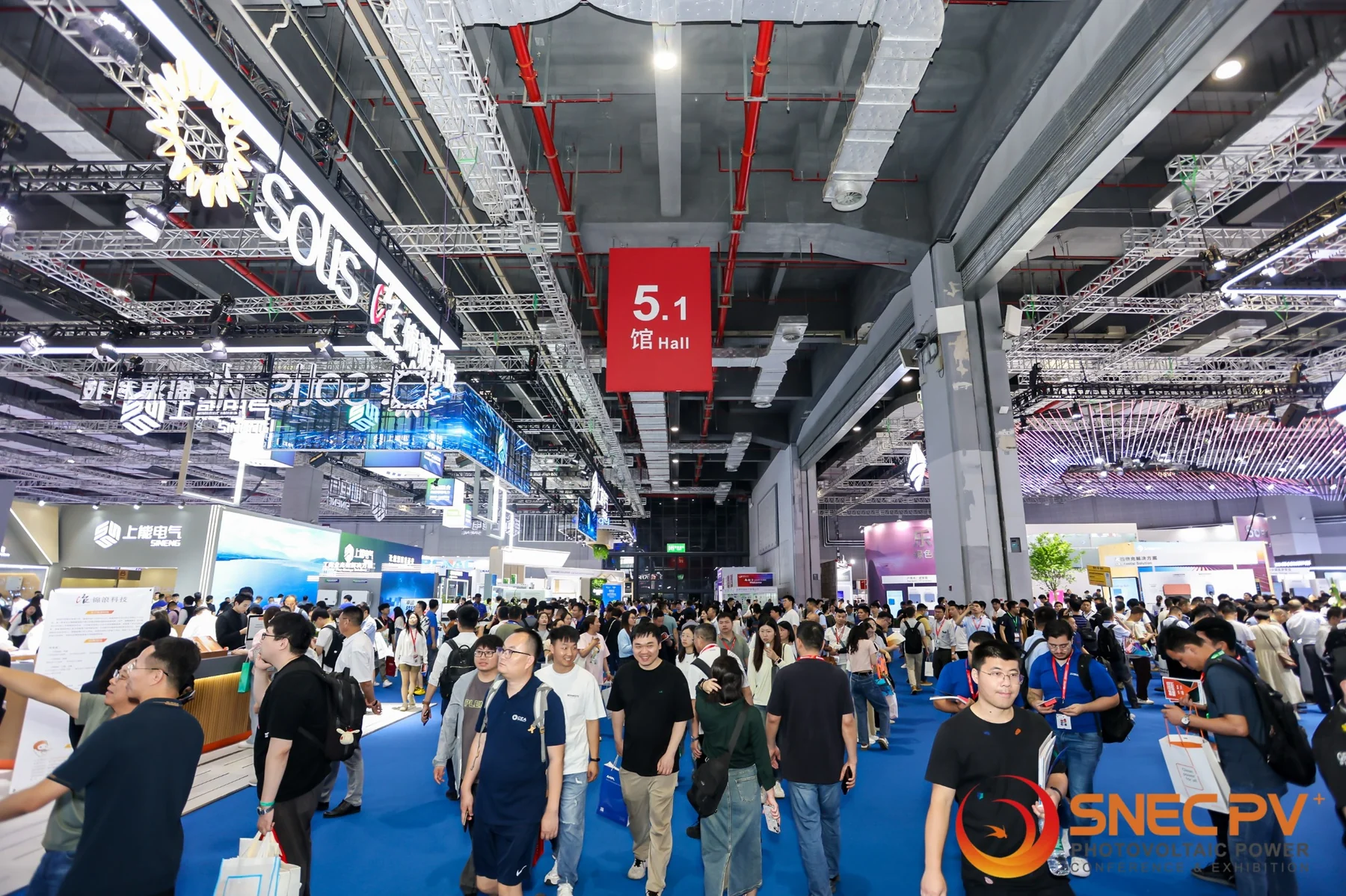 Crowded SNEC Shanghai hall with hall 5.1 signage and many renewable-energy booths